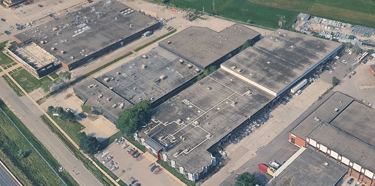 Aerial view of a commercial shopping center roof showing HVAC units, skylights, and roof condition ahead of an inspection